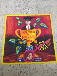 a painting on the ground that says girl child nations pride and is decorated with plants