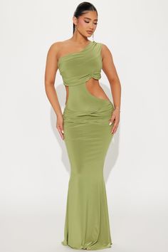 a woman wearing a green dress with one shoulder cut out and slited in the back