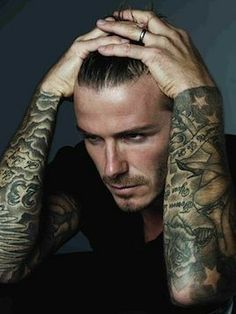 a man with tattoos on his arms and shoulder