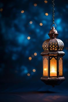 a lantern hanging from a chain with lights in the background