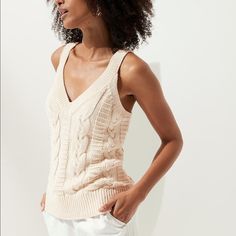 Sustainable: Made With Certified Organically Grown Cotton. V/Neck, Straight Hem, Semi-Fitted. Color Is Off-White Beige Cable Knit V-neck Top, Beige V-neck Cable Knit Top, Chic Cable Knit V-neck Top, Fitted V-neck Cable Knit Top, Stretch Cable Knit V-neck Top, Cream Cotton V-neck Knit Top, Beige V-neck Cotton Knit Top, Spring Cable Knit V-neck Tops, Organic Cotton Yarn