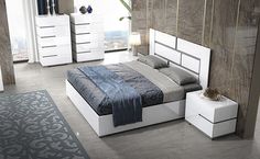 a bed room with a neatly made bed next to a night stand and dressers