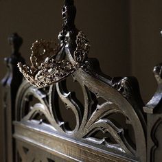 a metal crown on top of a wooden table