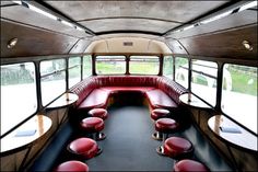 the inside of an old school bus with red seats