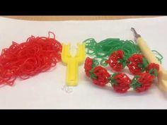 several different types of rubber bands and scissors on a white paper with red, green, and yellow handles