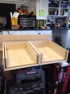 two wooden trays sitting on top of a workbench