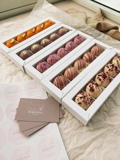 an assortment of desserts in boxes on a table