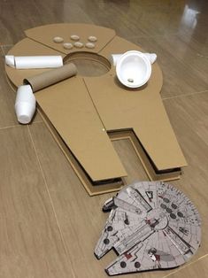 a cardboard star trek ship and other items on the floor