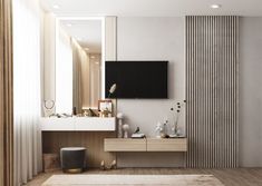 a tv mounted on the wall in a bathroom next to a vanity and mirror with vases