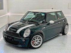 a black and white mini car parked in a garage