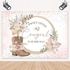 a wall hanging on the side of a wooden floor with flowers and boots in front of it