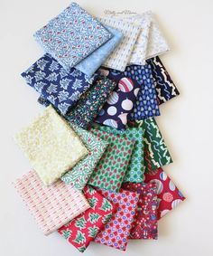 a pile of different colored ties laying on top of each other next to each other