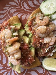 two pieces of bread with shrimp and avocado on it