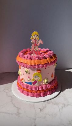 a pink and orange cake with a cartoon figure on top, sitting on a white plate