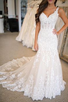 a woman in a white wedding dress posing for the camera