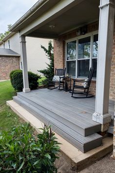 a porch with two rocking chairs on it