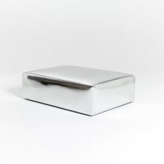 a silver box sitting on top of a white table