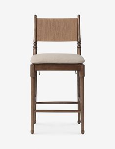 a wooden bar stool with a beige seat