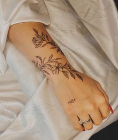 a woman's foot with flowers on it and the word hope written in black ink