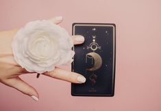 a woman's hand holding a white flower next to a card with the moon and stars on it