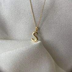 Make a statement with this custom initial letter necklace, crafted from high-quality 14K gold. Show off your personal style with a unique pendant, designed in the shape of a tiny balloon, featuring any letter of the alphabet that you choose. This necklace makes the perfect gift for any occasion, such as Valentine's Day, an anniversary, or just as a thoughtful surprise for that special someone in your life.  The necklace comes with a dainty chain and is perfect for layering with other necklaces, Tan Monogram Initial Pendant Necklace, Tan Initial Pendant Necklace, Yellow Gold Monogram Initial Necklace, Classic Tan Initial Pendant Necklace, Tan 14k Gold Necklaces With Initials, Initial Pendant Necklace With Name, Everyday Tan Necklaces With Initials, 14k Gold Initial Necklace With Name, Tan Initial Pendant Charm Necklaces