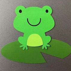 a paper cut out of a frog sitting on top of a leaf with its eyes closed