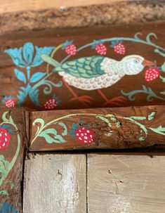 an old wooden bench painted with birds and berries