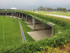 a green roof on the side of a building with grass growing all over it's sides