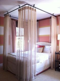 a bedroom with pink and white striped walls