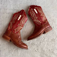 Good Vintage Condition. Leather Embroidered Cowboy Boots By Lucchese In Dark Red And Brown With White, Yellow And Blue Detailing. Western Cowgirl Aesthetic, A Versatile Wardrobe Statement Shoe That Can Be Dressed Up Or Worn Casually. Pull-On Cowboy Boots With Scalloped Shaft And Almond Toe. Two-Tone Leather With Embroidered Western Topstitching Throughout, See Video. Pull Strap For Easy On/Off. Leather Sole With Standard Pegging And Hand-Hammered Brass Nails. Distressed, Worn-In Finish. Note: Mo Cowgirl Aesthetic, Statement Shoe, Western Cowboy Boots, Cowgirl Boots, Vintage Leather, Cowboy Boots, Bootie Boots, Leather Upper, Cowboy