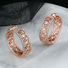 Introducing our exquisite 14K Rose Filigree Flower Hoop Earring, adorned with dazzling Crystals from Swarovski. This elegant piece seamlessly combines timeless design with modern glamour, making it a must-have accessory for any occasion. Crafted with precision, the filigree flower detailing adds a touch of delicacy to the hoop earring, creating a harmonious blend of sophistication and femininity. The radiant Crystals from Swarovski catch and reflect light, ensuring you sparkle with every step. T Rose Gold Pierced Jewelry With Cubic Zirconia, Pierced Rose Gold Jewelry With Cubic Zirconia, Cubic Zirconia Plated Hoop Earrings, Rose Gold Cubic Zirconia Pierced Jewelry, Rose Gold Hoop Earrings With Diamond Accents For Anniversary, Fine Jewelry Hoop Earrings With Plating For Anniversary, Rose Gold Flower-shaped Hoop Earrings Gift, Rose Gold Flower Shaped Hoop Earrings Gift, Crystal Hoop Earrings For Anniversary