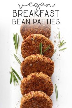 four vegan breakfast bean patties on a white plate with rosemary sprigs