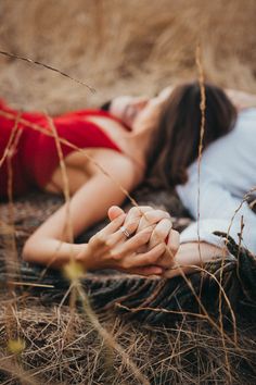 a woman laying on the ground with her hands together