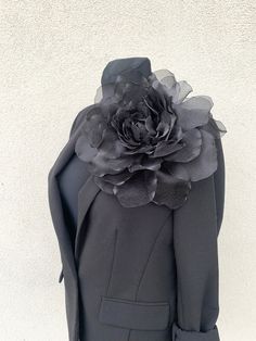 a black jacket with a flower on the back