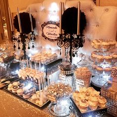 a table topped with lots of desserts and cupcakes