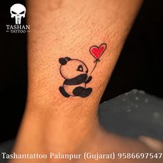 a tattoo with a panda holding a heart shaped balloon