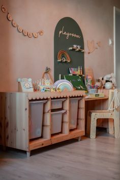 a playroom with toys and other items on the floor in front of a chalkboard