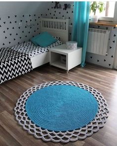 a bedroom with two twin beds and blue rugs on the wooden floor next to each other