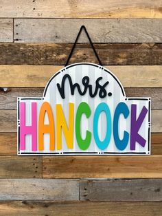 a sign that says mr and mrs hancock hanging on a wooden wall with the word mr and mrs