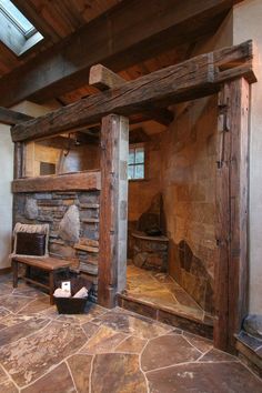 the interior of a rustic log cabin with stone flooring