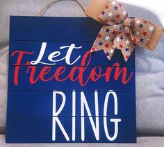 a wooden sign that says let freedom ring in red, white and blue stars on it