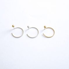 These Unique Earrings are designed to look like a two piece ear jacket but with the simplicity and ease of an ear threader. They are Simple and Modern enough to be worn on a daily basis. These tiny 3mm Balls come in either Brass, Sterling Silver or 14k Gold with 40mm sterling silver posts for the sterling and brass and 14k gold for the gold option. Delicate and minimalist earrings you must have for casual wear or minimalist chic fancy occasions! + Earring Shape - Ball/Sphere + Ball Size - 3mm Di Minimalist White Gold Plug Earrings, Modern Round Cartilage Earrings With Ear Wire, Minimalist Hoop Ear Cuff With Matching Earrings, Minimalist Single Plug Earring, Minimalist Single Plug Earring For Everyday, Minimalist Pierced Hoop Ear Climbers, Minimalist White Gold Cartilage Earring Sold Individually, Everyday Minimalist Small Hoop Plug Earrings, Minimalist Hoop Plug Earrings For Everyday