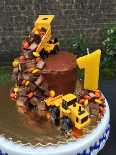 a birthday cake with construction vehicles on it