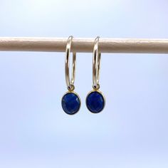 Lapis lazuli (blue) mini oval (7x9mm) crystal gemstone drop earrings on 22 Carat gold vermeil small hoop (16mm wide) sleeper  ear wires. Sold separately on 925 Sterling Silver hoops. Sleeper ear wires are tubular in design with one end slotting a little into the other to form an endless ring. They are lightweight and uncomplicated. Vermeil is a high quality form of gold plating in which a thick layer of gold (this must be more than 2.5 microns and between 14 Carat and 22 Carat) is coated over 92 Blue Hypoallergenic Hoop Jewelry, Hypoallergenic Blue Hoop Jewelry, Blue Hypoallergenic Small Hoop Jewelry, Hypoallergenic Blue Small Hoop Jewelry, Faceted Hoop Earrings As Gift, Nickel-free Blue Small Hoop Jewelry, Hypoallergenic Sapphire Jewelry As Gift, Hypoallergenic Sapphire Jewelry For Gifts, Faceted Hoop Jewelry For Gifts