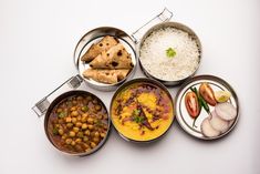 four bowls filled with different types of food