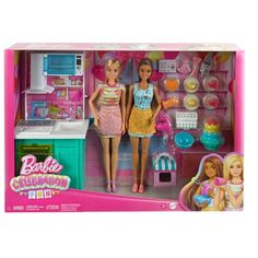 two barbie dolls in a pink kitchen set