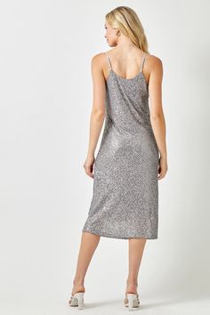 Light up the night with the Shine Brighter Midi Dress! This dazzling piece is constructed with a soft grey fabric and silver sequins, making you look as brilliant as a star. With its cowl neck design and straight, slip style, you'll be shining all night! Style it with a simple block heel to complete your effortlessly chic look. Shine on! Grey, silver sequins Cowl neck Thin, adjustable straps Straight fit The material is Self & Lining 100% Polyester. The midi dress runs true to size. The model is Sequin Slip Dress, Light Up The Night, Night Style, Silver Dress, Grey Fabric, Neck Designs, Cowl Neck, Women's Intimates, Midi Length