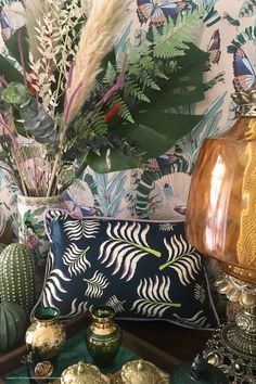 a table topped with lots of vases filled with plants