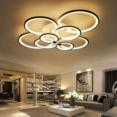 a modern living room with circular lights in the ceiling