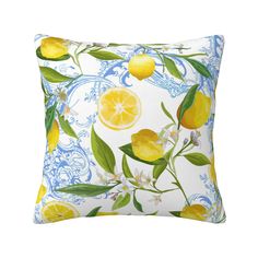 a yellow and blue pillow with lemons on the front, green leaves and white flowers